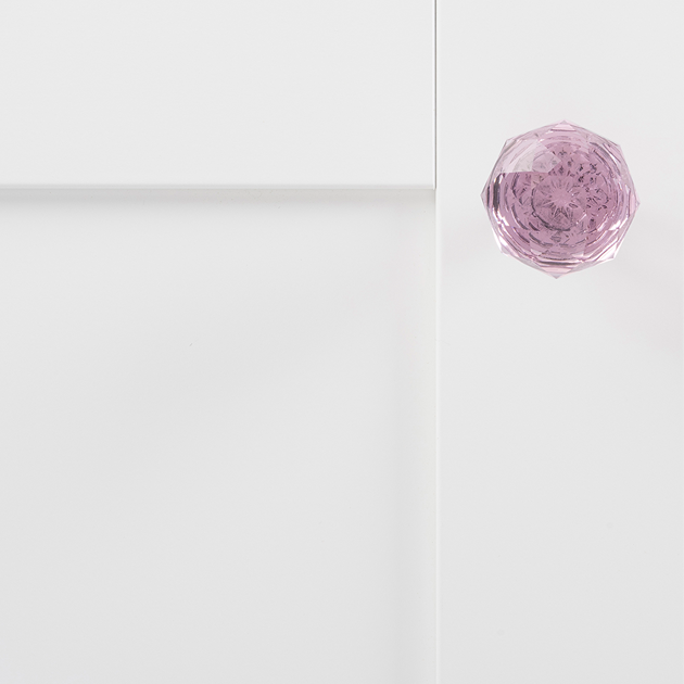 Faceted pink glass knob with chrome base on white cabinet door for cabinet hardware in home improvement collection under $50
