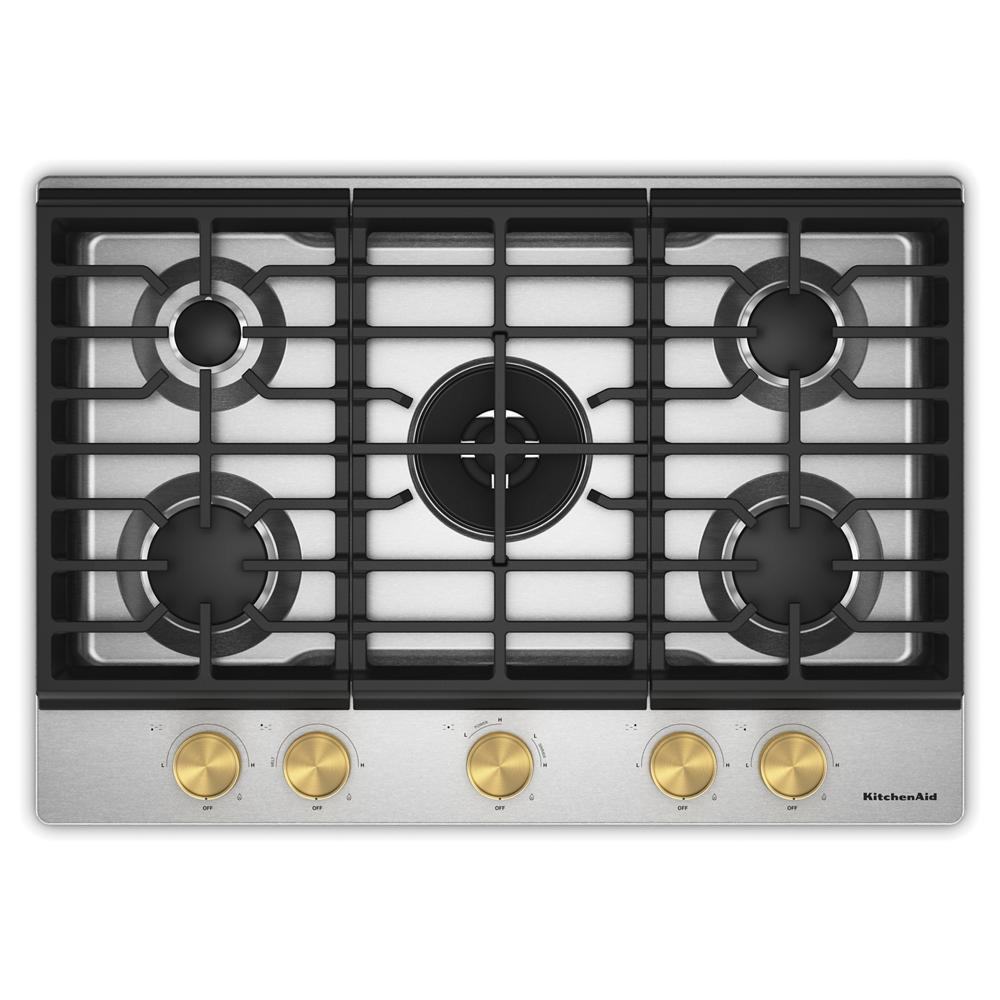 Top view of a stainless steel gas cooktop with five burners and gold-toned control knobs, part of KitchenAid cooktops for kitchenware and home improvement.