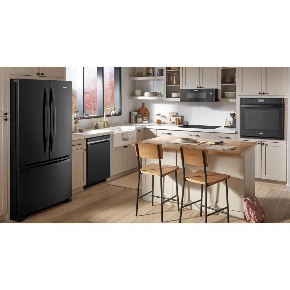 Modern kitchen with black Whirlpool appliances including fridge, dishwasher, microwave, oven, and induction cooktop on light wood floor