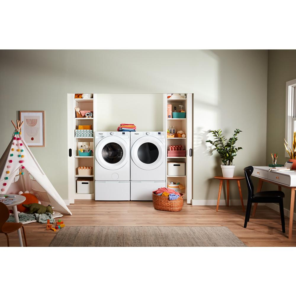 Bright laundry room with white front load washer and dryer in cabinetry, toys, plants, and a desk with chair nearby