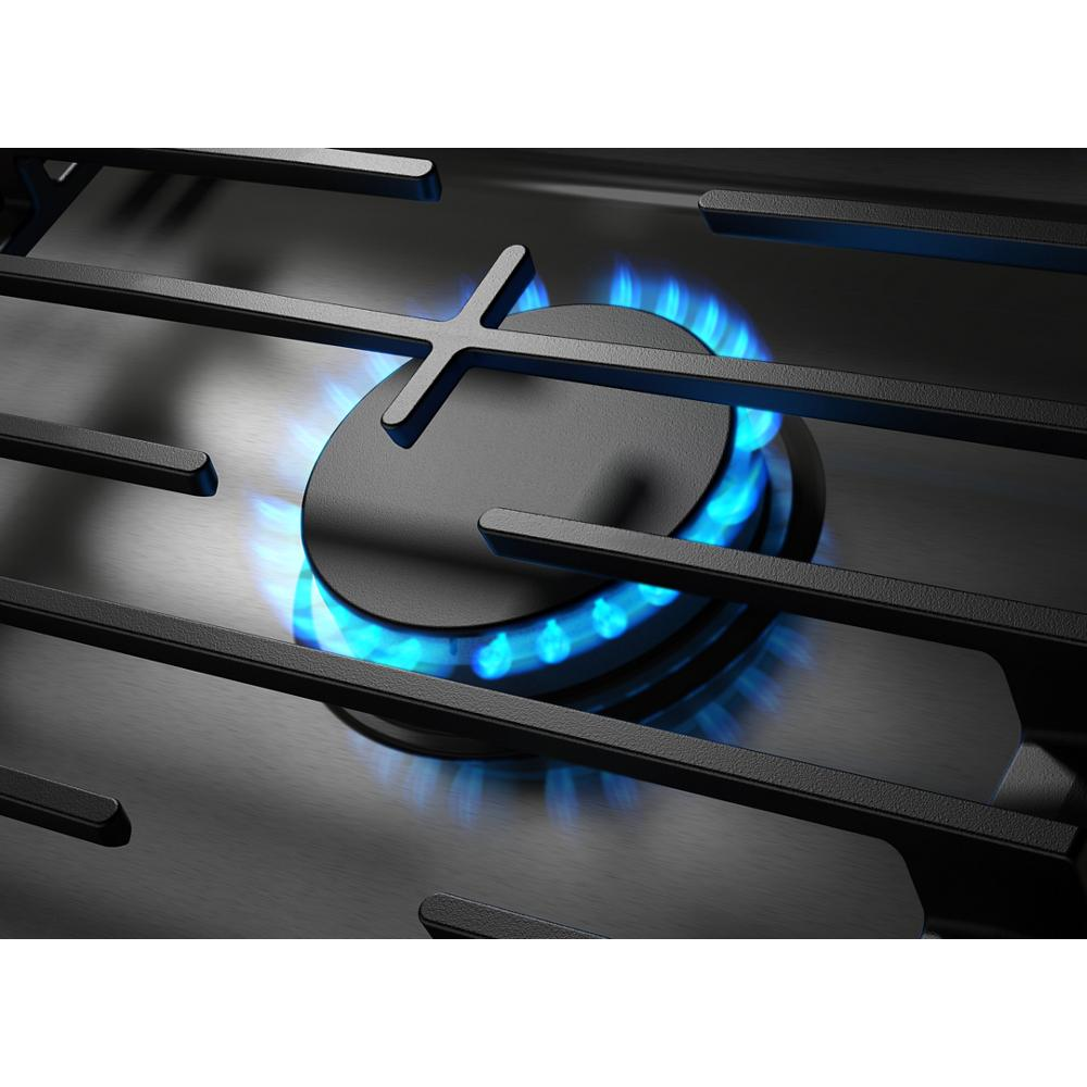 Close-up of a gas burner lit with blue flame beneath hinged cast-iron grates on a stainless steel cooktop surface