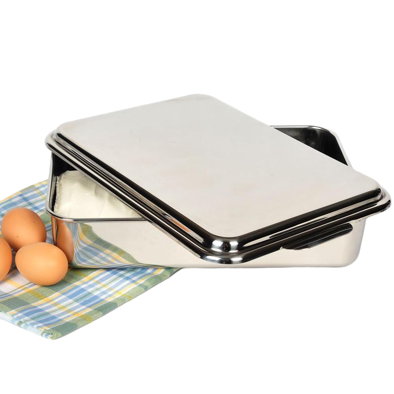 Rectangular stainless steel cake pan with removable lid placed on checkered cloth near brown eggs in kitchenware collection