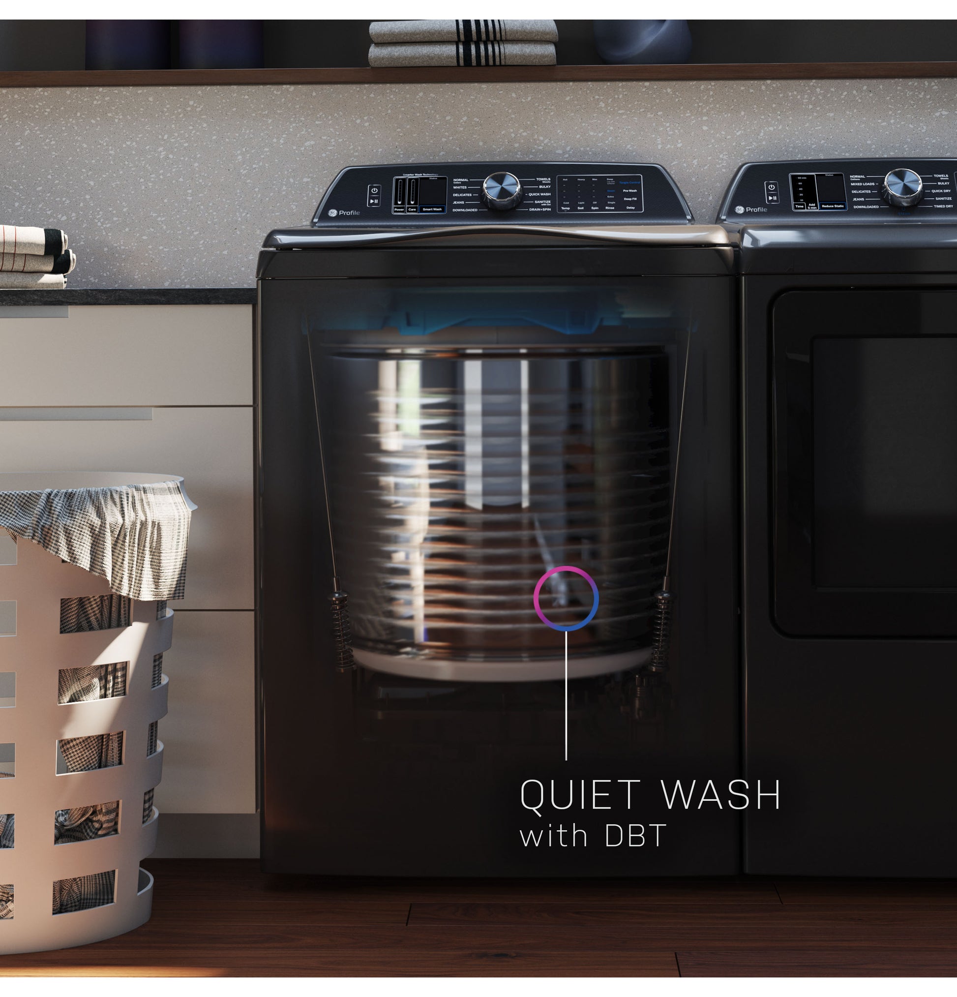 Black top load washer showing transparent drum and quiet wash feature in modern laundry room with basket and cabinetry