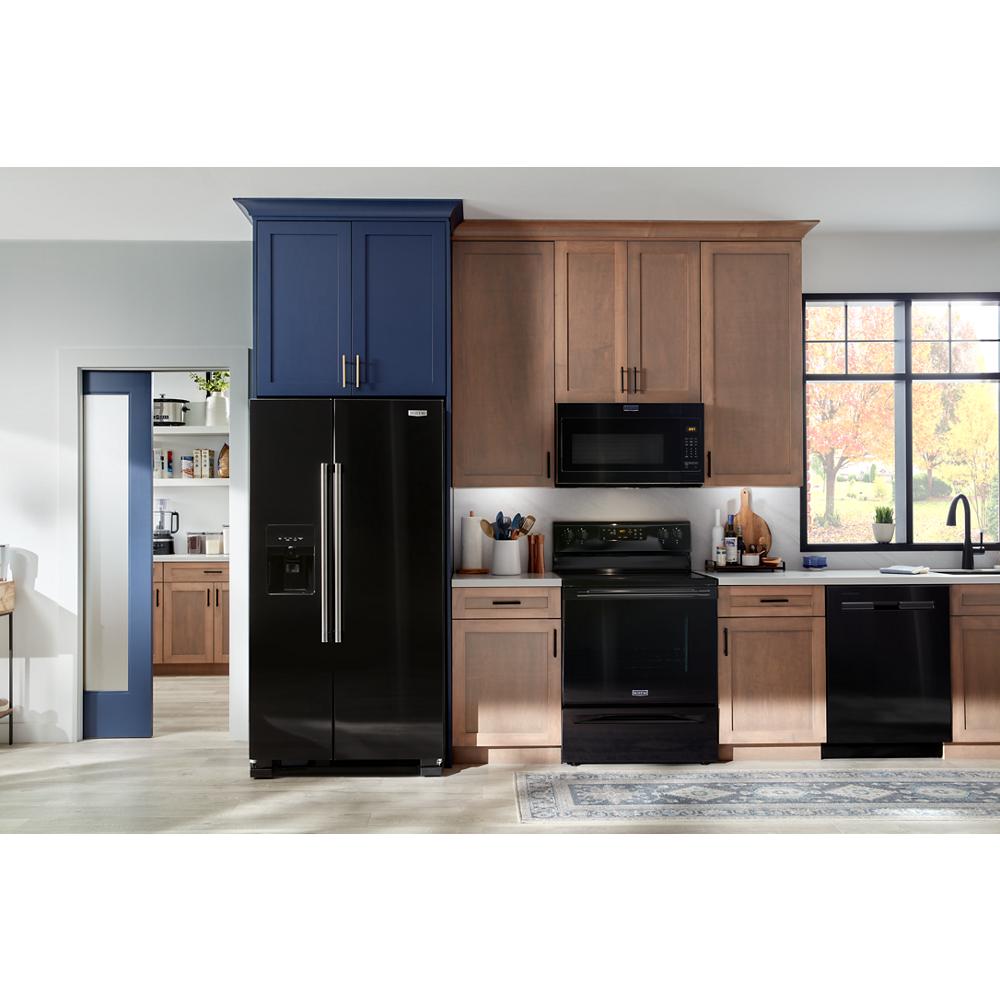 Black flush built-in microwave above black stove with blue and wood kitchen cabinets and black appliances in home setting