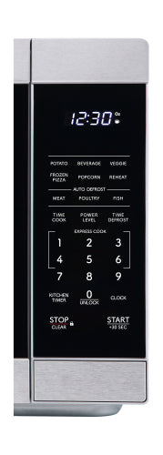 Close-up of stainless steel microwave control panel with digital clock and preset cooking buttons in kitchen appliances collection