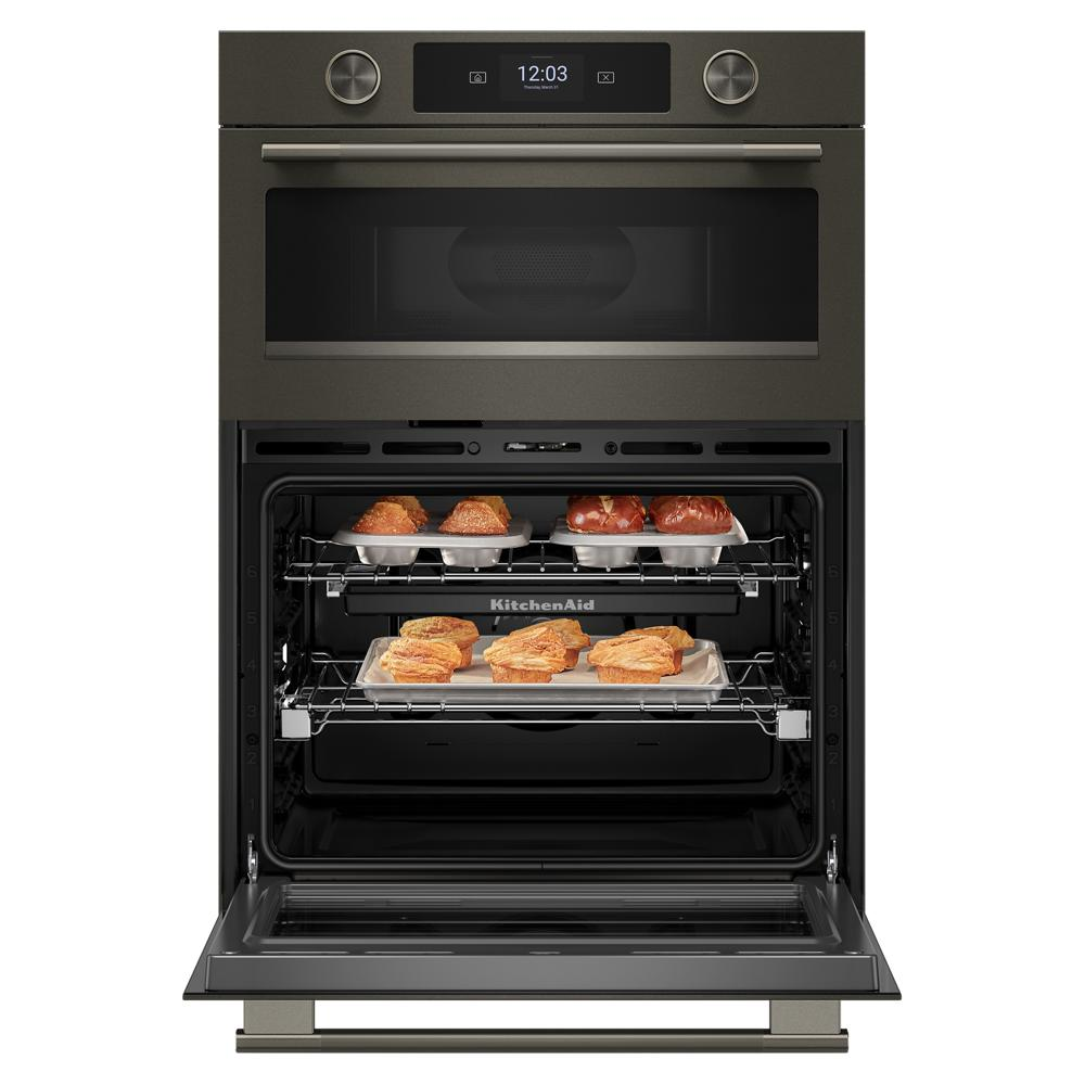 Open black ore electric wall oven with baked pastries on two racks and LED touchscreen display
