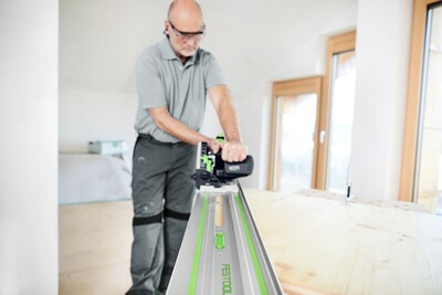 Man using Festool guide rail with a power saw for accurate cuts in woodworking tool accessories and home improvement tasks