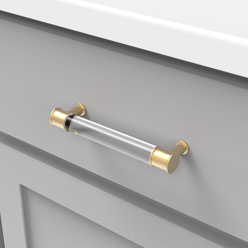 Clear acrylic drawer pull with brushed golden brass ends installed on a gray cabinet for furniture hardware updates under $50