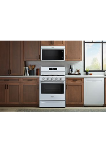 White 30-inch gas range with five control knobs and digital display in kitchen setting with wooden cabinetry and appliances