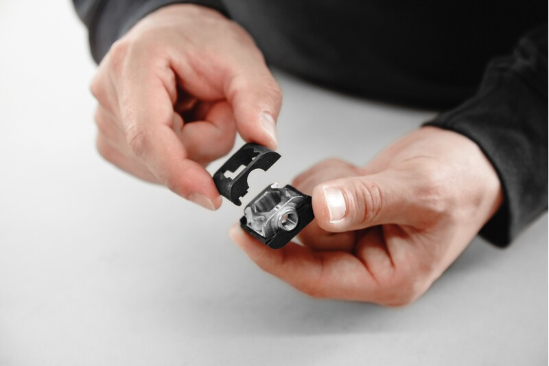 Hands holding black Domino Connector Extension Shells for woodworking tool accessories and home improvement collections