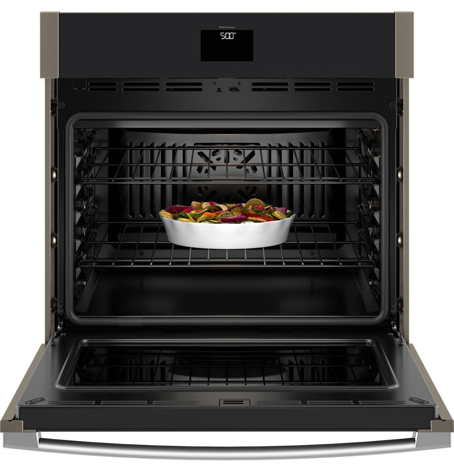 Open built-in wall oven with convection fan and ceramic dish of roasted vegetables inside from Wall Ovens collection
