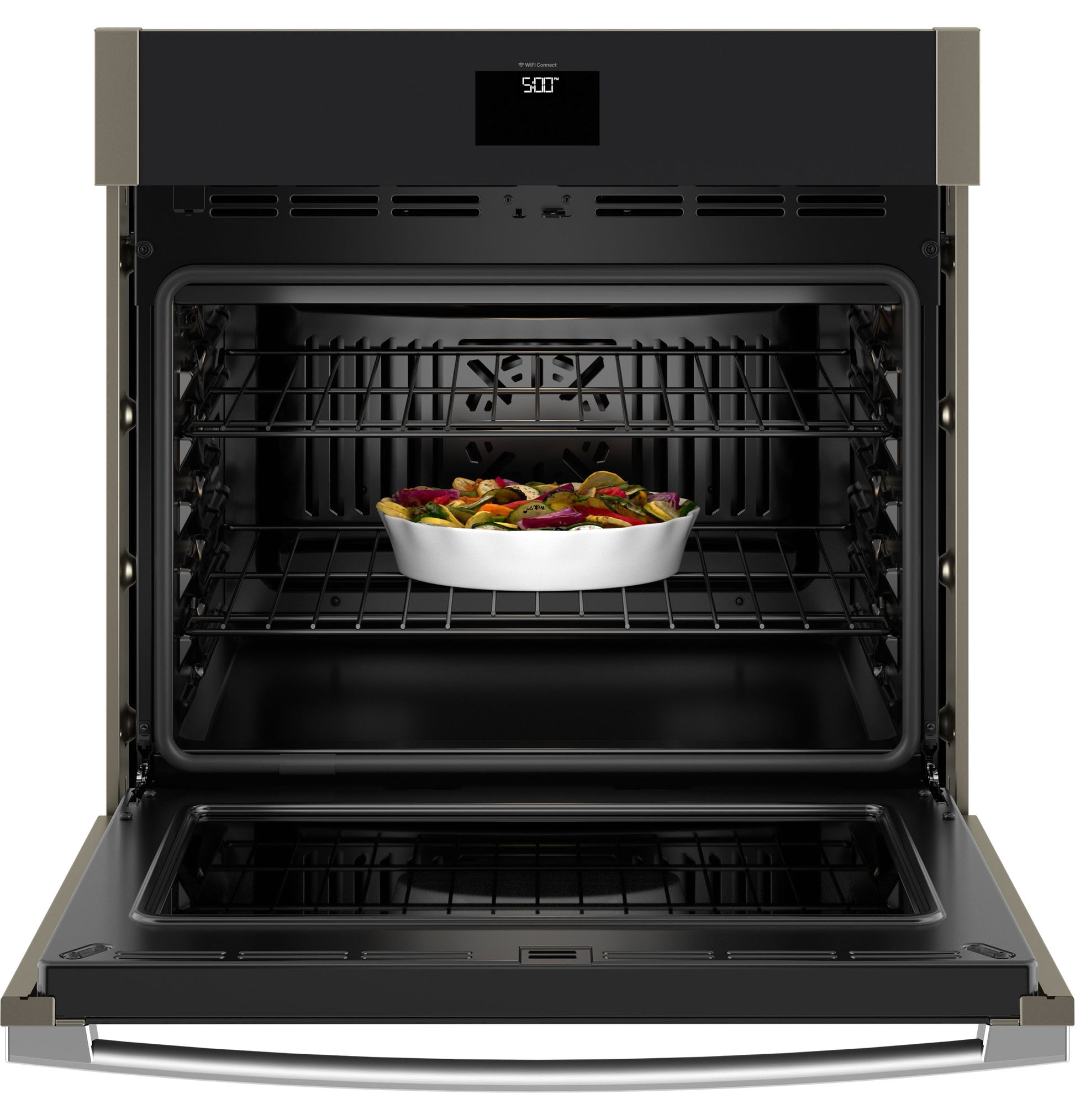 Open built-in wall oven with convection fan and ceramic dish of roasted vegetables inside from Wall Ovens collection