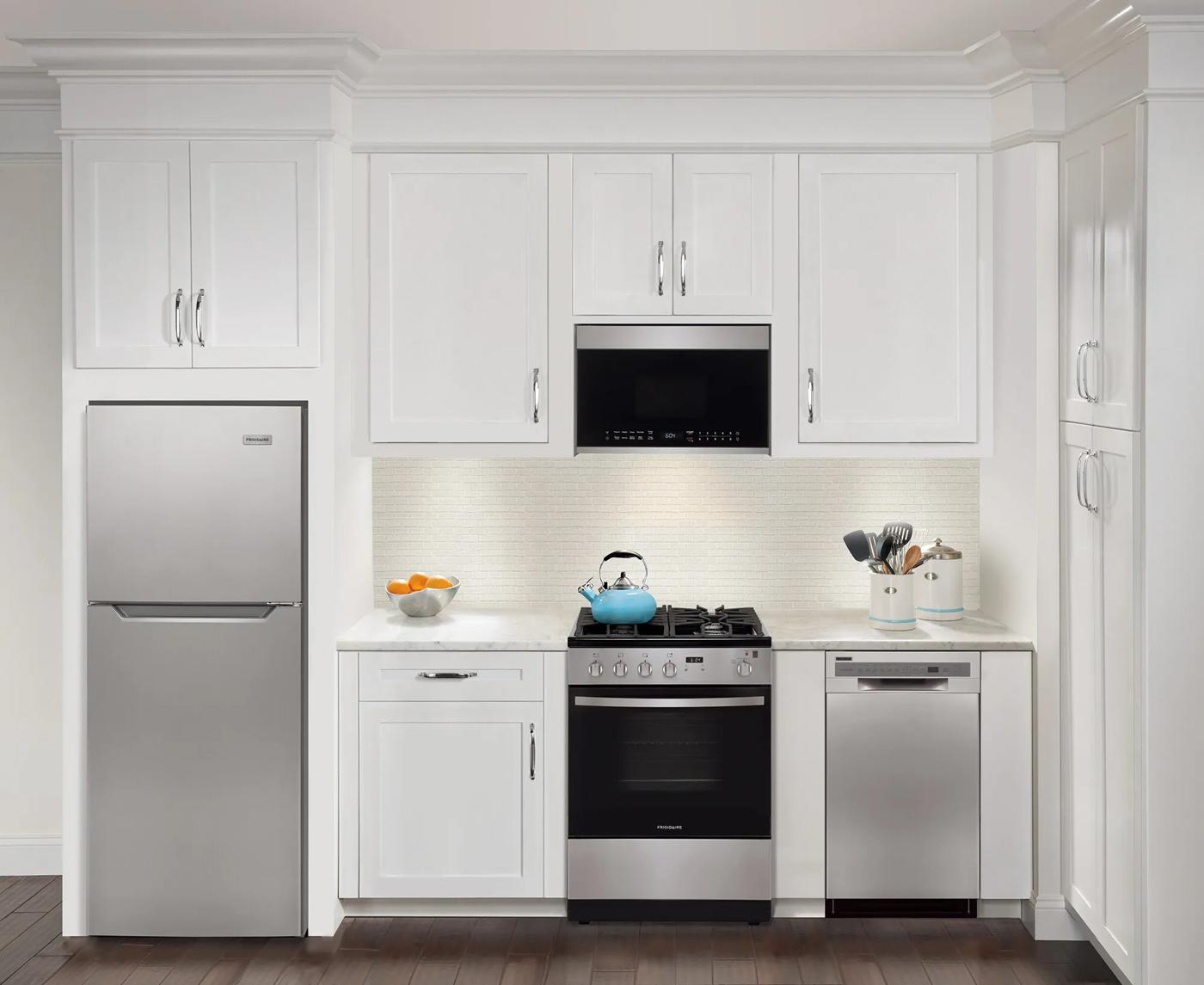 Modern kitchen setup featuring stainless steel dishwasher and appliances with white cabinetry from Appliances collection