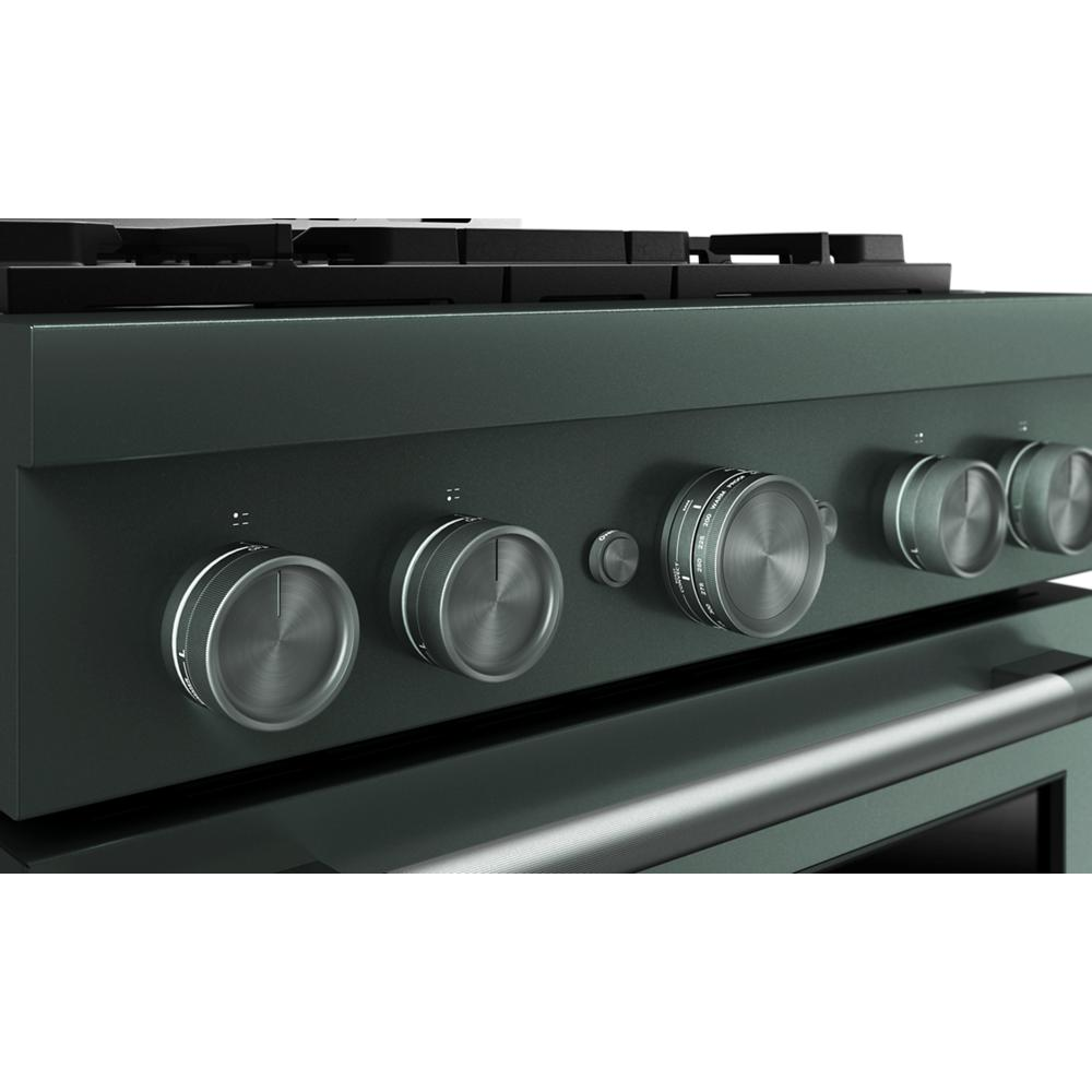 Close-up of dark green commercial-style gas range control panel with five brushed metal knobs and one button