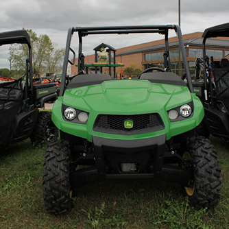 Green mid-size utility vehicle with Maxxis Bighorn tires and protective roll cage for outdoor work and home improvement tasks