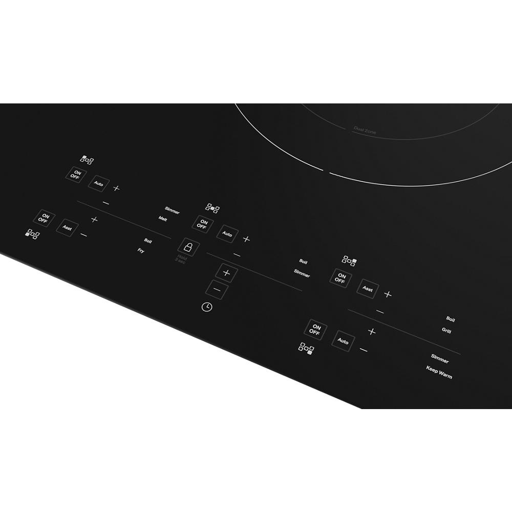 Smooth black induction cooktop panel with sensor touch controls and five cooking elements from KitchenAid appliances collection
