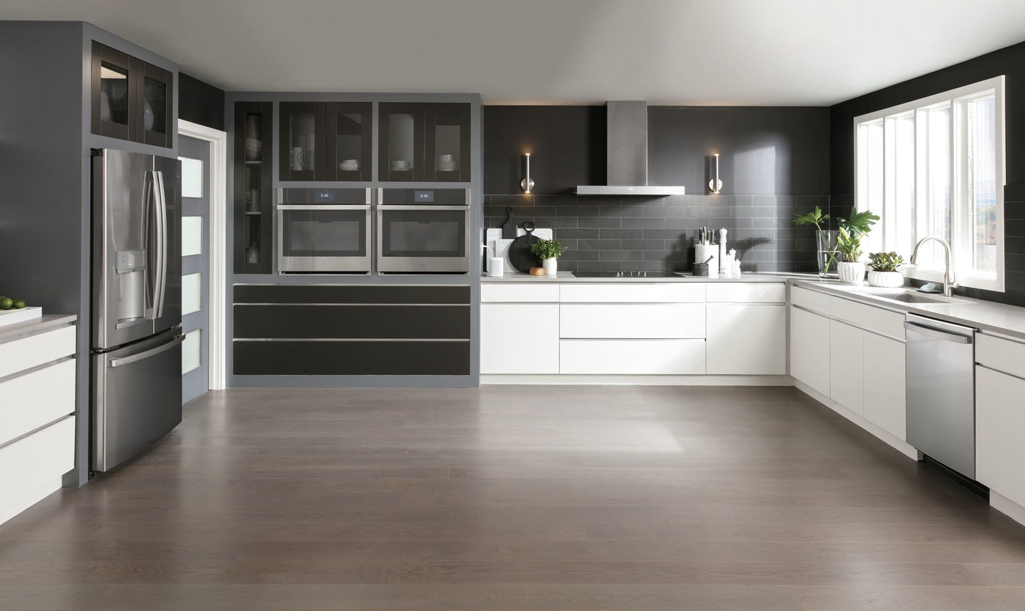 Modern kitchen with sleek white cabinetry, stainless steel appliances, and a stainless wall mount vent hood for home improvement