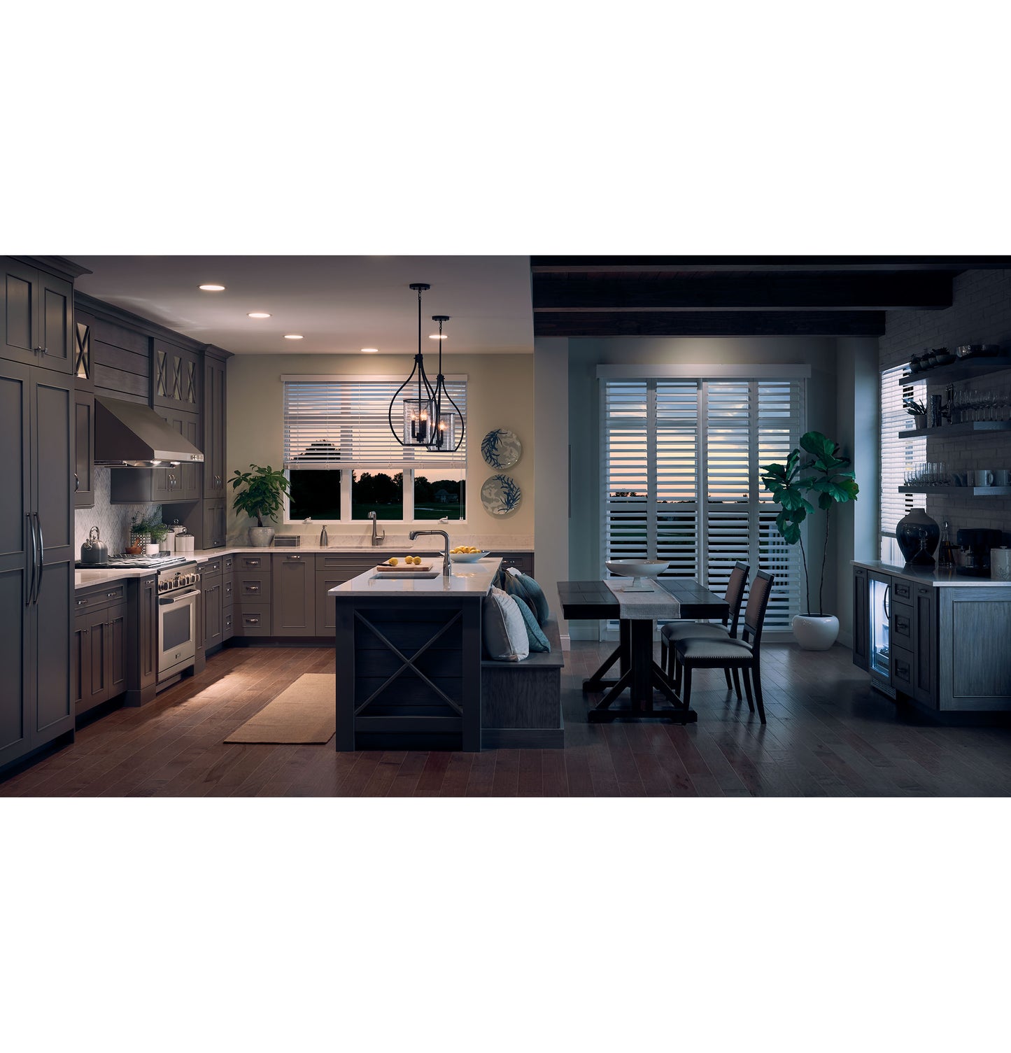 Modern kitchen with stainless steel range hood, gray cabinetry, island seating, and dining area with shuttered windows