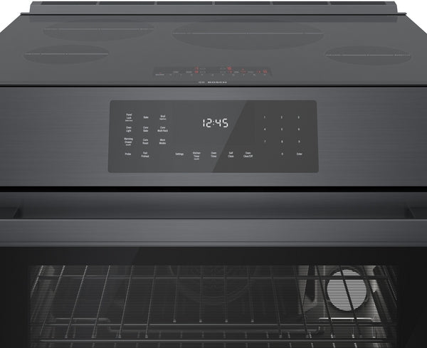 Black stainless steel induction range control panel with digital clock and touch-sensitive oven settings in kitchen appliances collection
