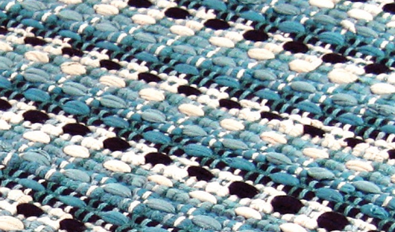 Close-up of woven blue and white cotton rag rug showcasing textured pattern for area rugs and flooring collections