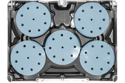Set of blue circular abrasives with holes neatly stored in a black plastic organizer for woodworking tool storage and workshop use