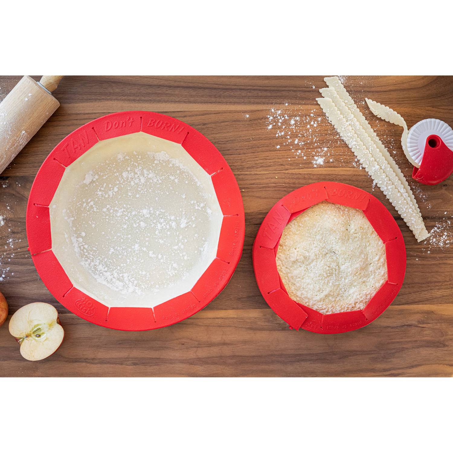 Red silicone pie crust shields fitted on unbaked and baked pies with kitchen tools for bakeware and kitchenware use