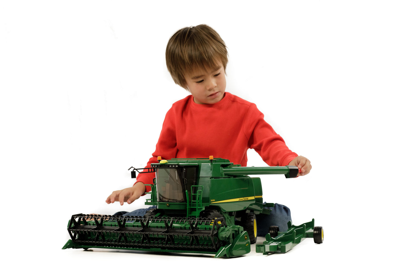 Young boy interacting with a detailed Bruder John Deere T670i combine harvester toy for Toys & Games and Bruder Toys collections