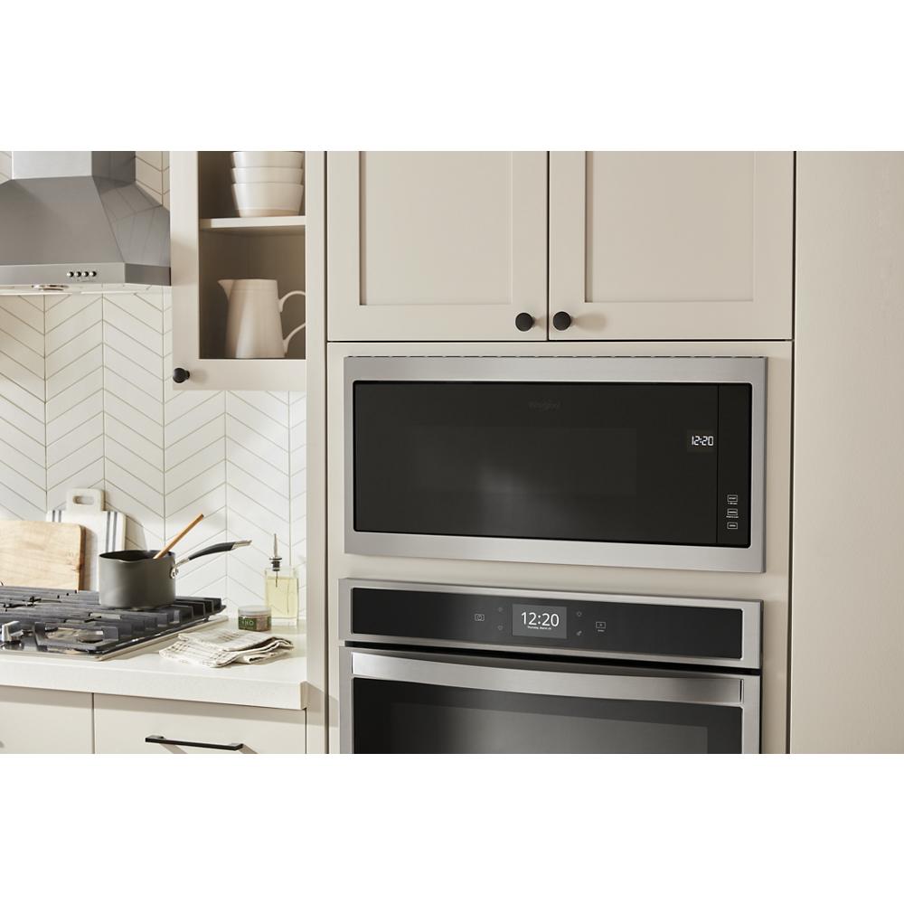 Built-in microwave with slim trim and digital display integrated into light kitchen cabinetry from Appliances and Kitchen & Kitchenware collections