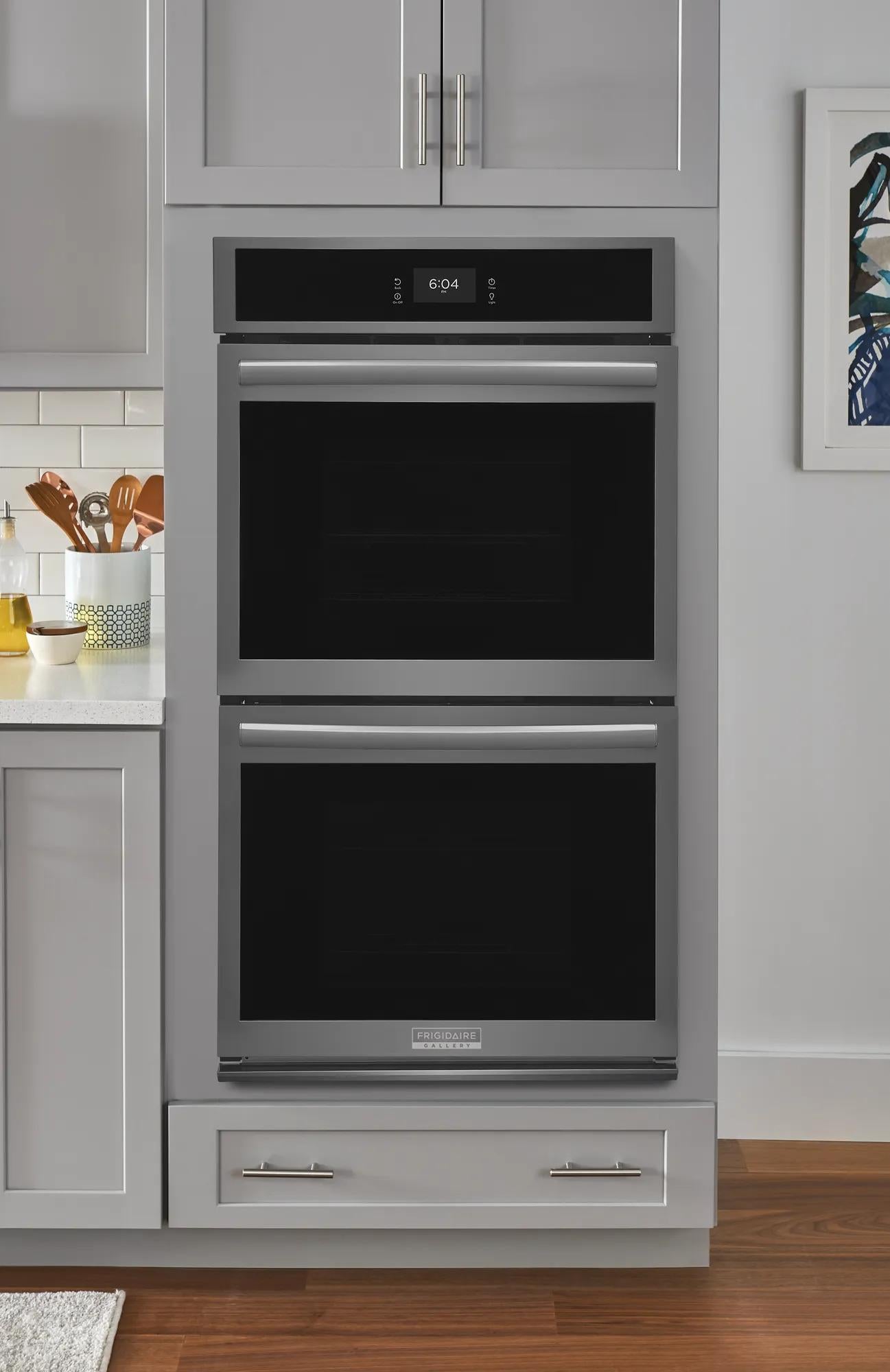 Built-in stainless steel double wall oven with digital clock and modern handles in kitchen and appliances collections