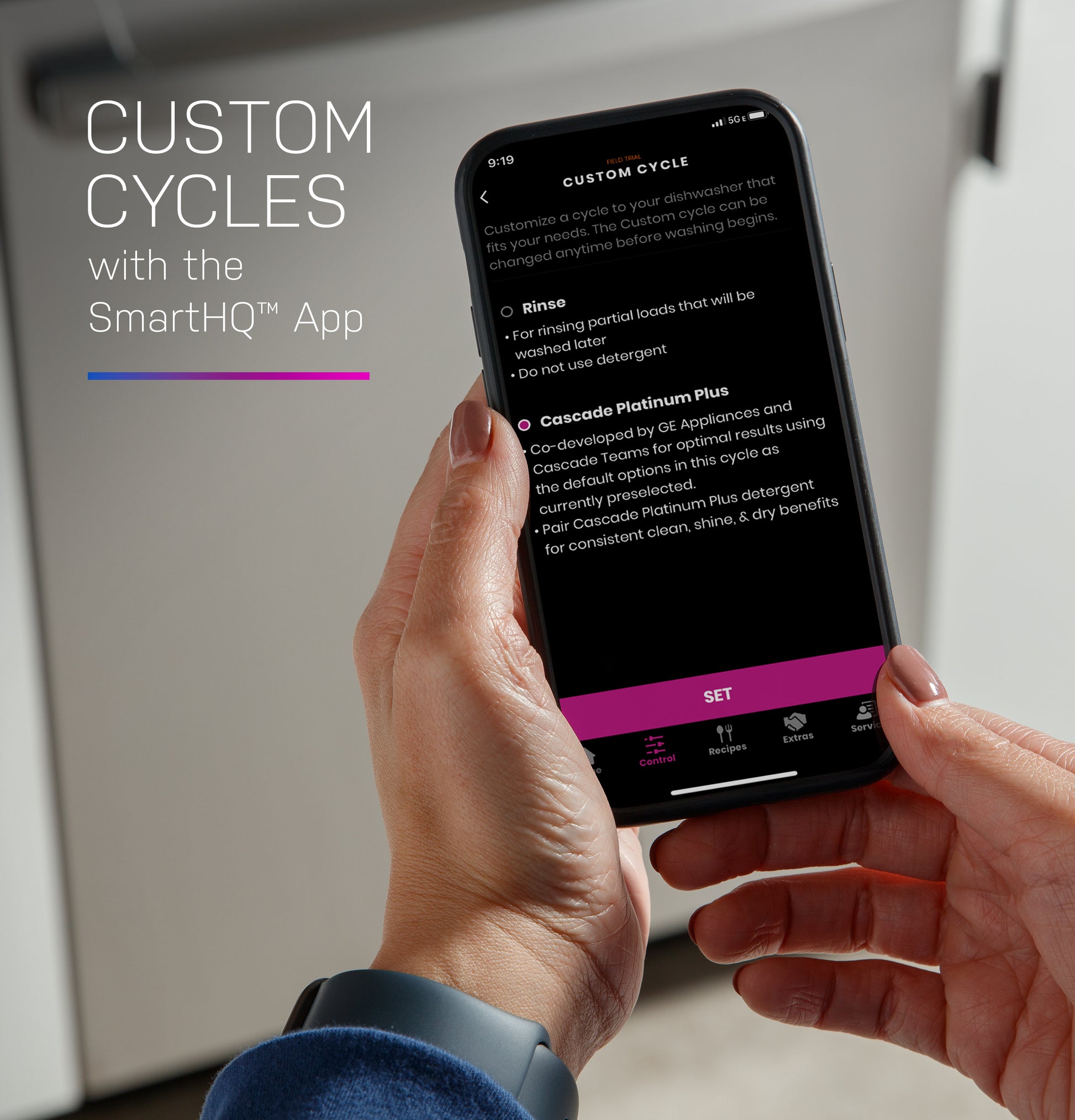 Person holding smartphone showing custom dishwasher cycle settings within SmartHQ app for kitchen appliances collection