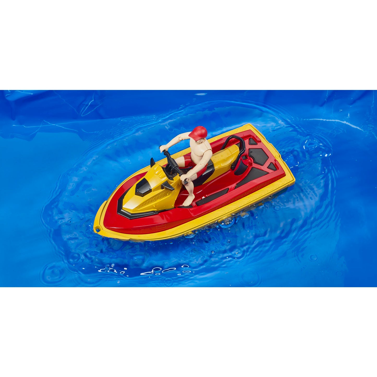 Red and yellow toy watercraft with lifeguard figure wearing red helmet floating on water from Bruder Toys collection