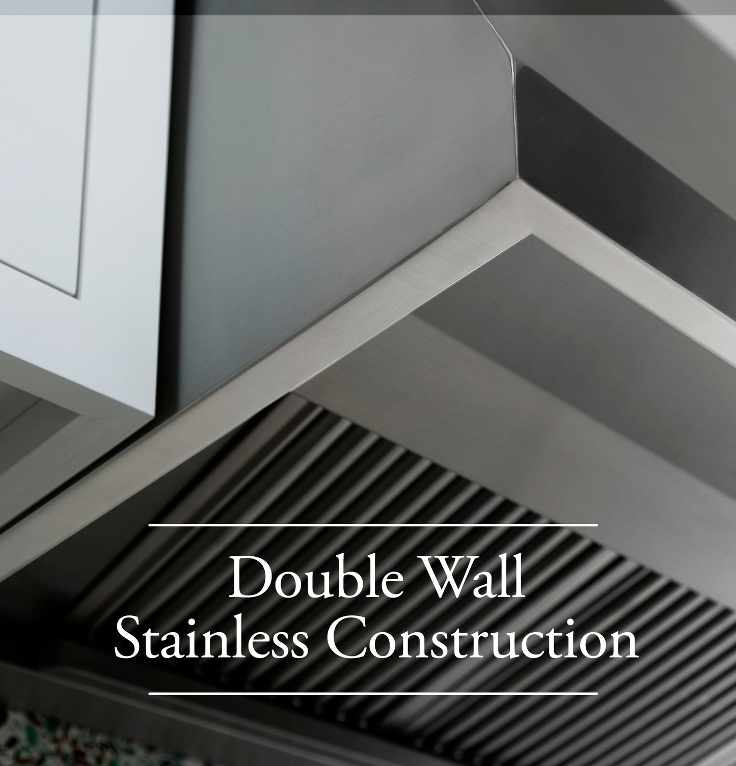 Close-up view of stainless steel double wall design on professional kitchen range hood from appliances collection
