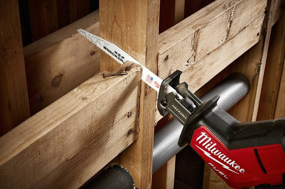 Reciprocating saw with Milwaukee blade cutting through wood framing for tools and home improvement tasks