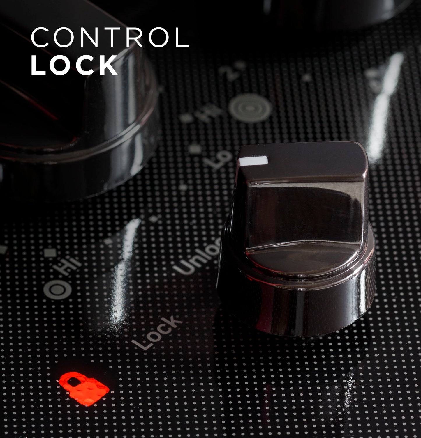 Close-up of black knob control on electric cooktop highlighting illuminated red control lock icon in kitchen appliance setting