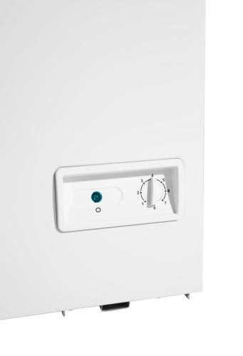 Close-up of white chest freezer front panel with power indicator light and temperature control dial in home appliance setting