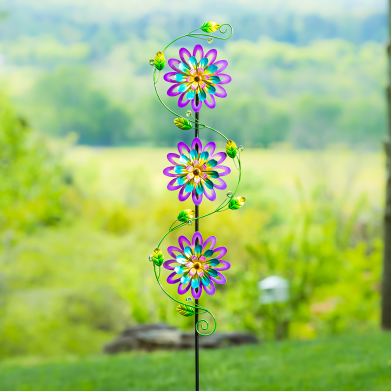 Colorful metal garden stake featuring three vibrant violet flowers with green decorative leaves for outdoor decor