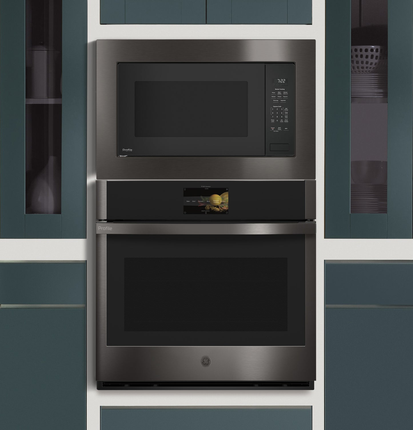 Built-in dark stainless steel microwave and oven combo integrated into blue cabinetry in modern kitchen setting