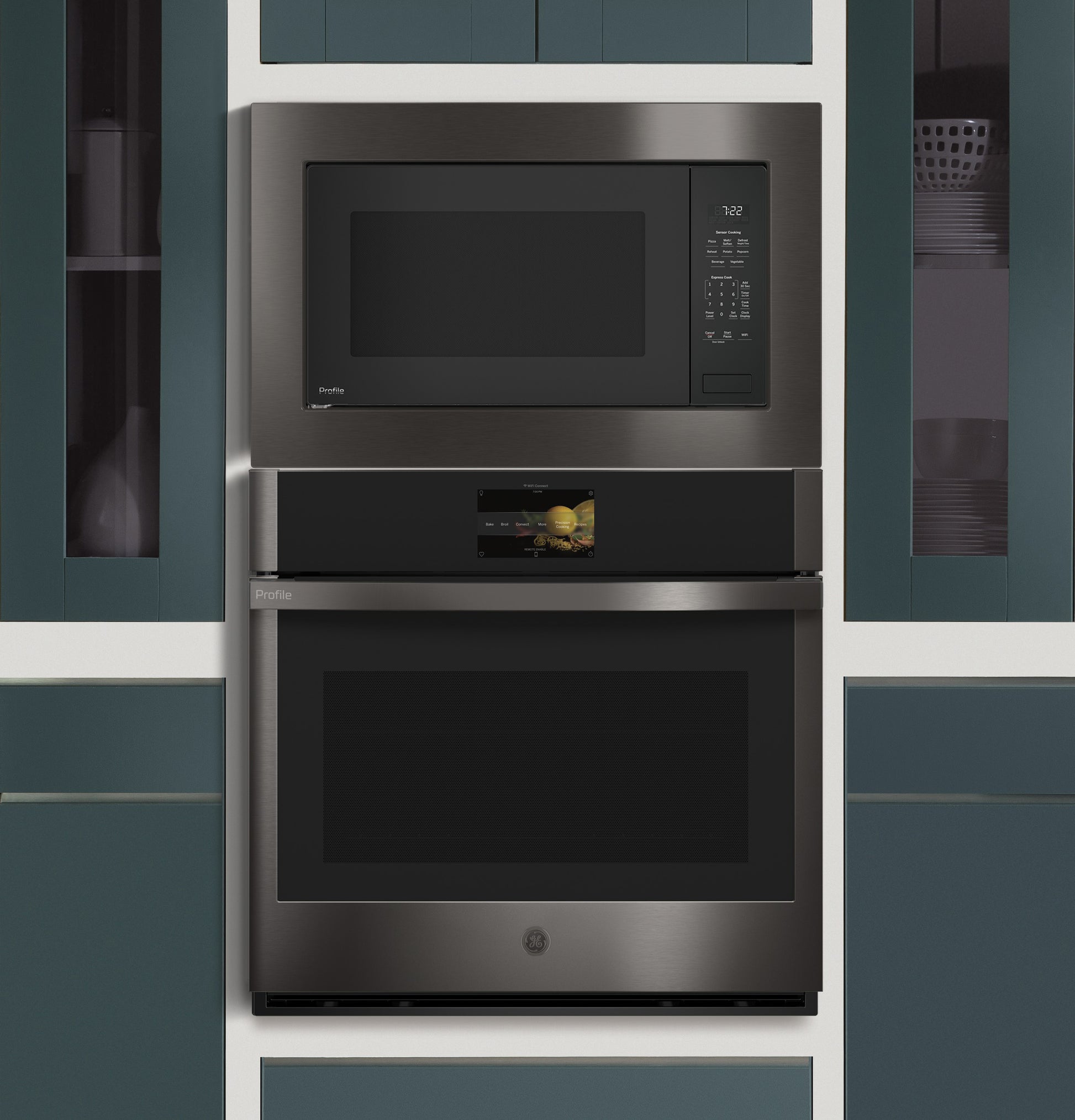 Built-in dark stainless steel microwave and oven combo integrated into blue cabinetry in modern kitchen setting