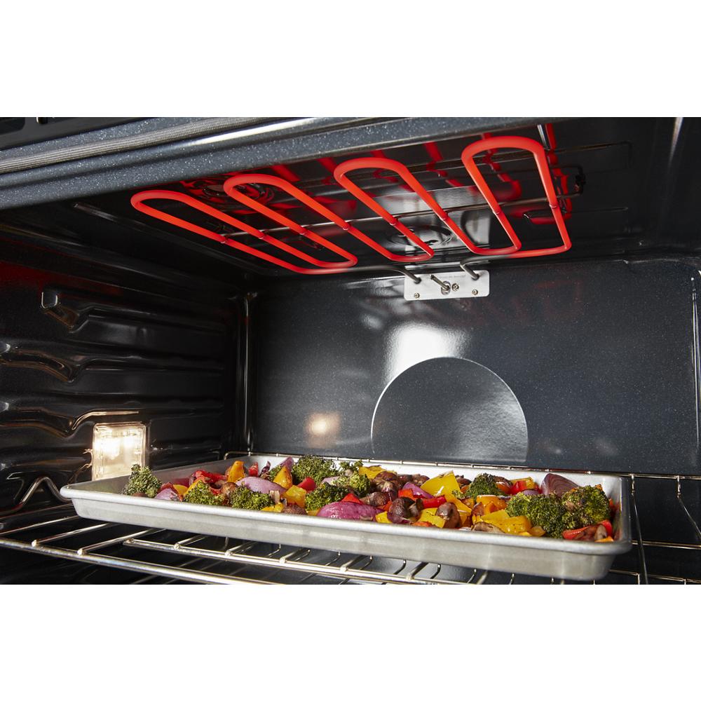 Inside view of a double wall oven with a baking tray of colorful roasted vegetables on the oven rack from Appliances collection