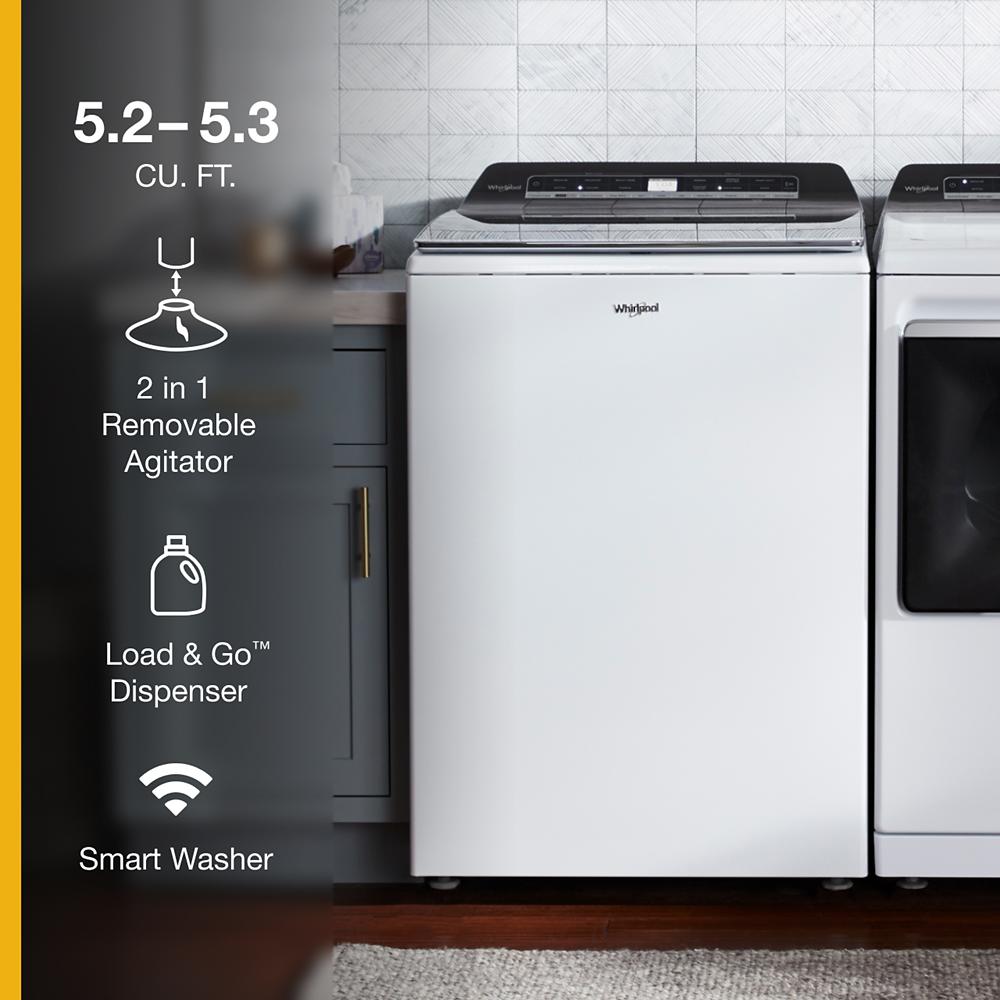 White Whirlpool top load washer with digital controls beside matching dryer in modern laundry room setting