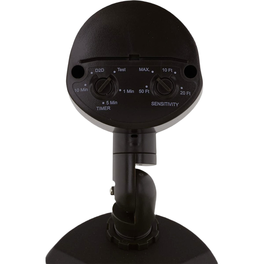 Close-up of bronze motion sensor security light controls with timer and sensitivity adjustment knobs for outdoor lighting.