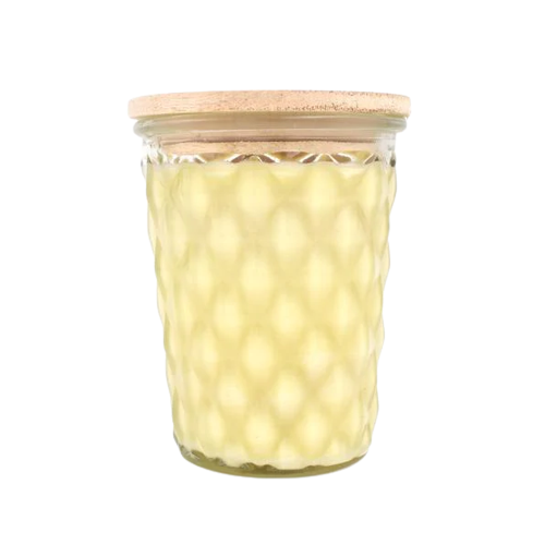 Yellow wax candle in textured glass jar with natural wood lid for cozy home ambiance and decoration