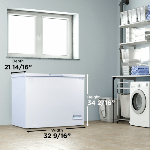 White chest freezer with dimensions displayed, placed in a modern laundry room with shelving and washer appliances