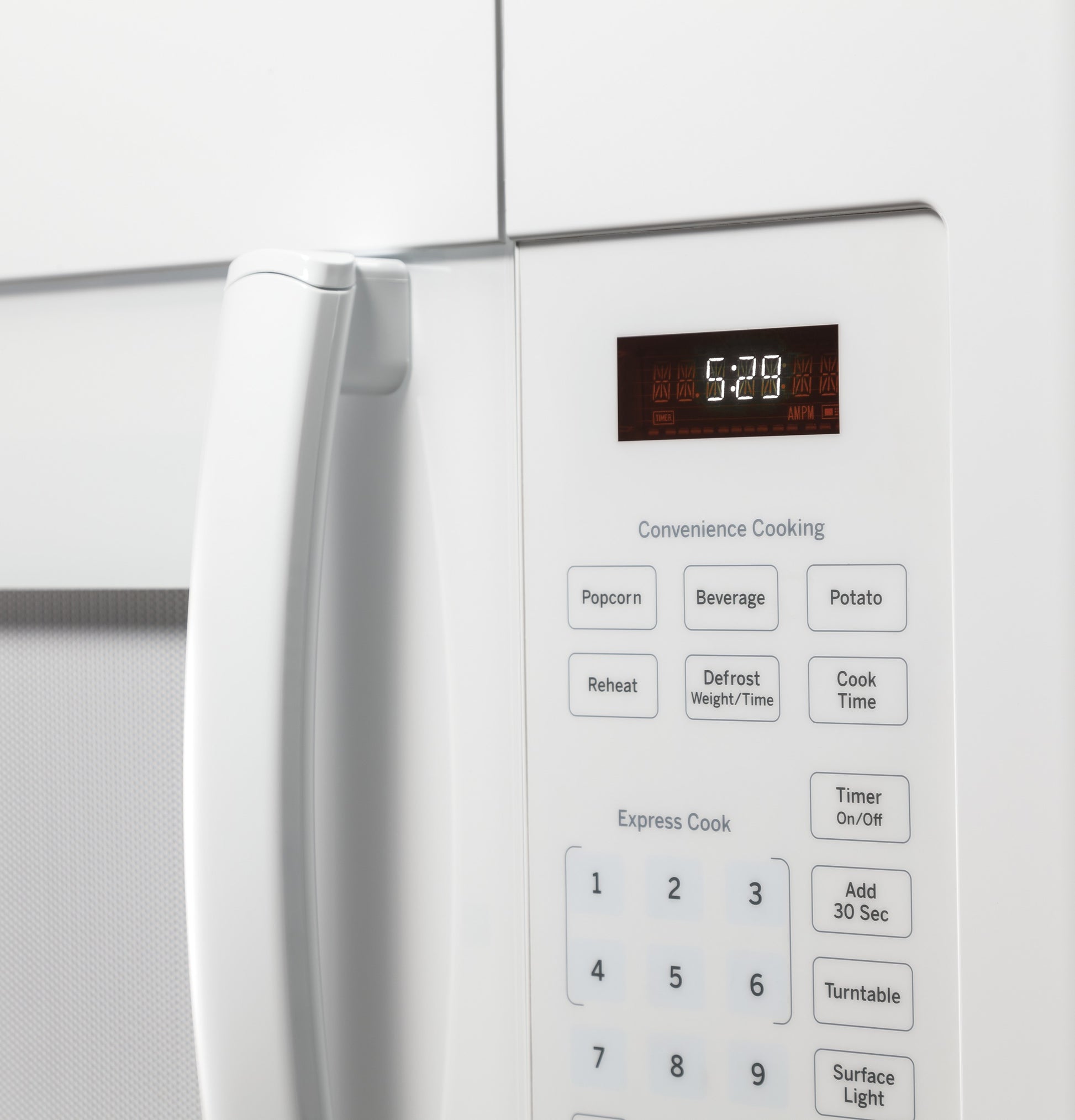 Close-up of white over-the-range microwave oven control panel with digital display and preset cooking options