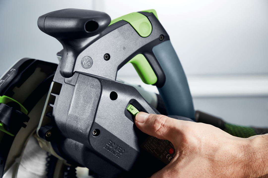 Close-up of hand operating settings dial on Festool plunge cut track saw in electric power tools collection