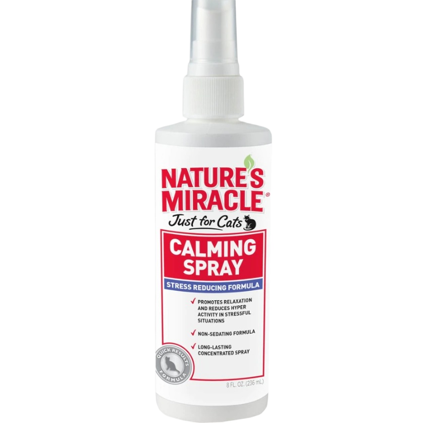 White spray bottle of Nature's Miracle calming spray for cats with red and blue label text on a clear background