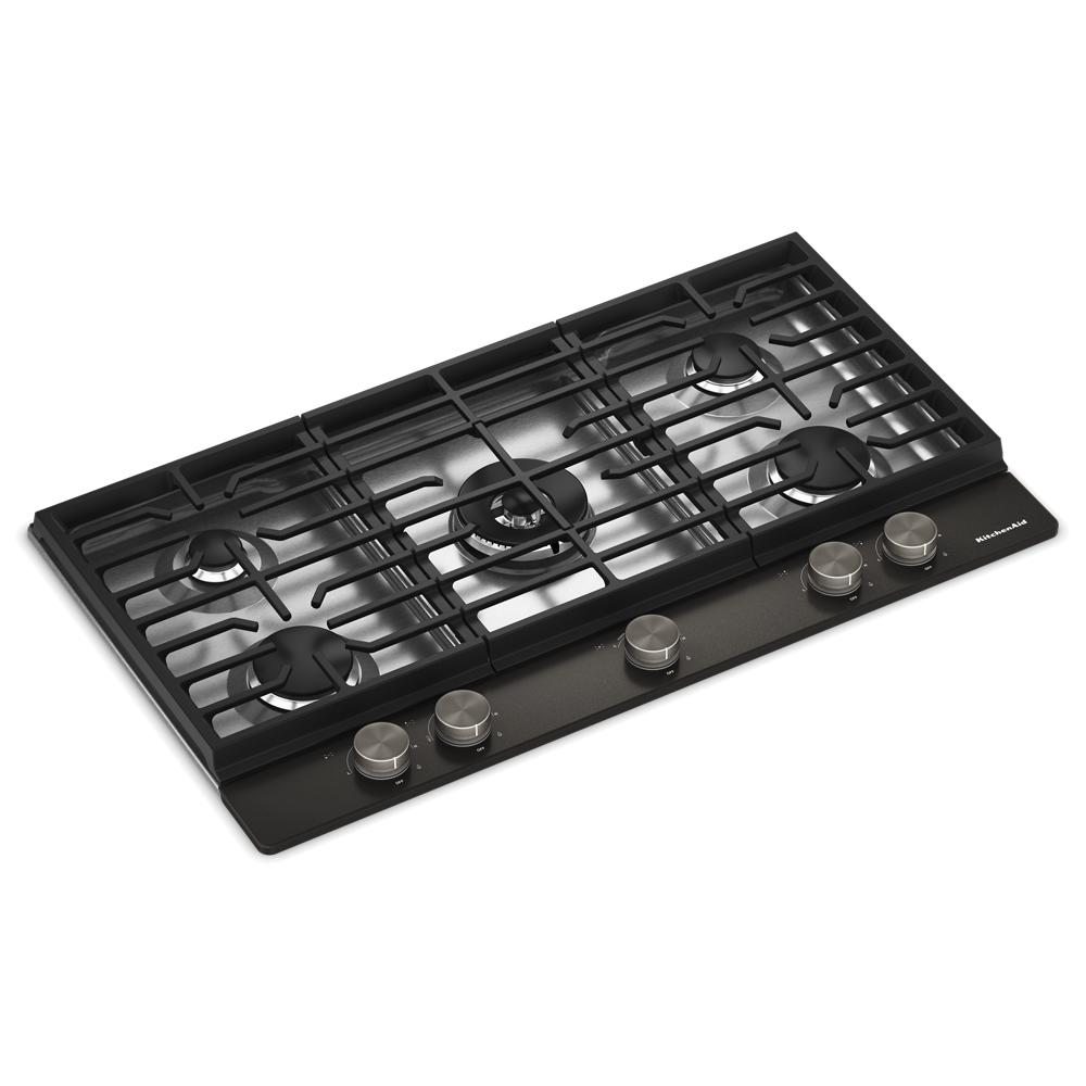 Angled view of a black KitchenAid gas cooktop featuring five burners, integrated wok grate, and metal control knobs, part of Cooktops, Gas Cooktops, Kitchen & Kitchenware, All Products, KitchenAid, Appliances, and Ranges & Cooktops collections.