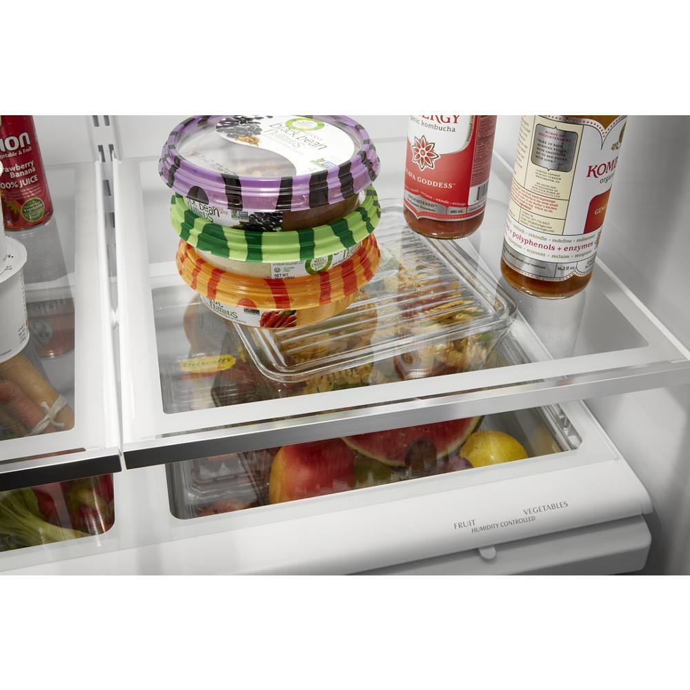 Interior view of a refrigerator showing clear crisper drawers and stacked packaged food on glass shelving from appliances collection