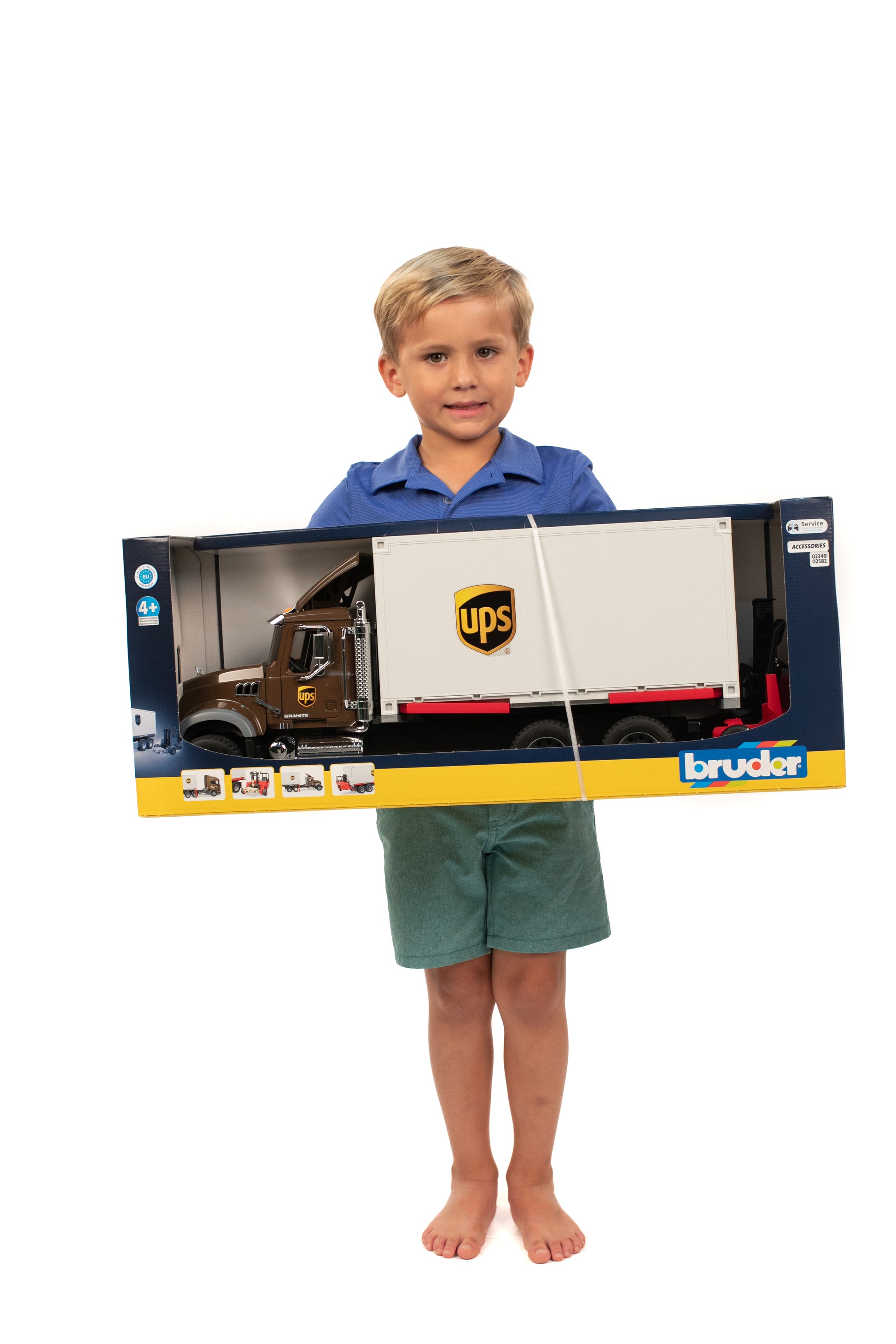 Young boy holding a large UPS logistics toy truck in packaging from Bruder Toys in Vehicles & Remote Controlled Toys collection