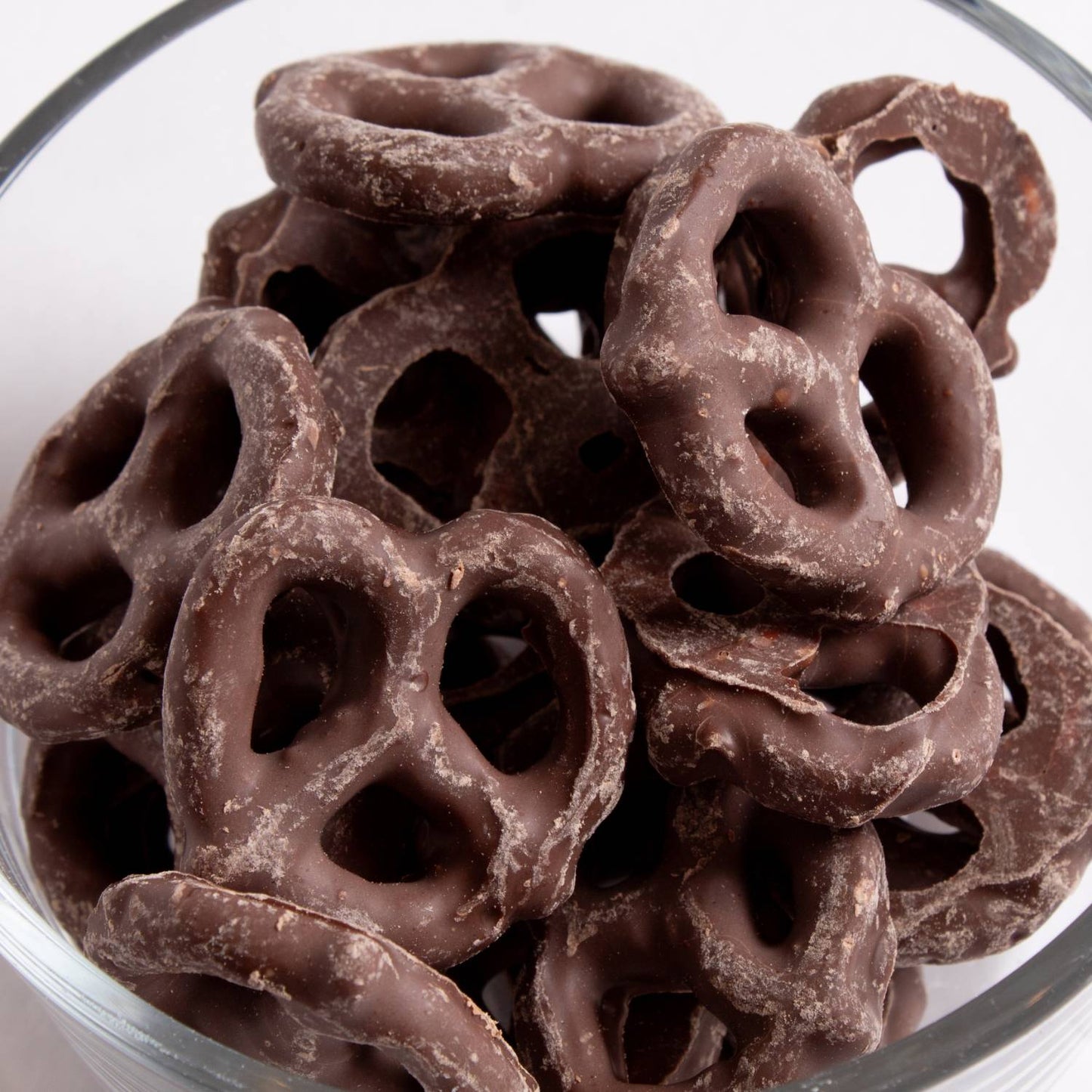 Glass bowl holding mini pretzels coated in rich chocolate from Chips & Snacks and Food & Beverage under $50 collections